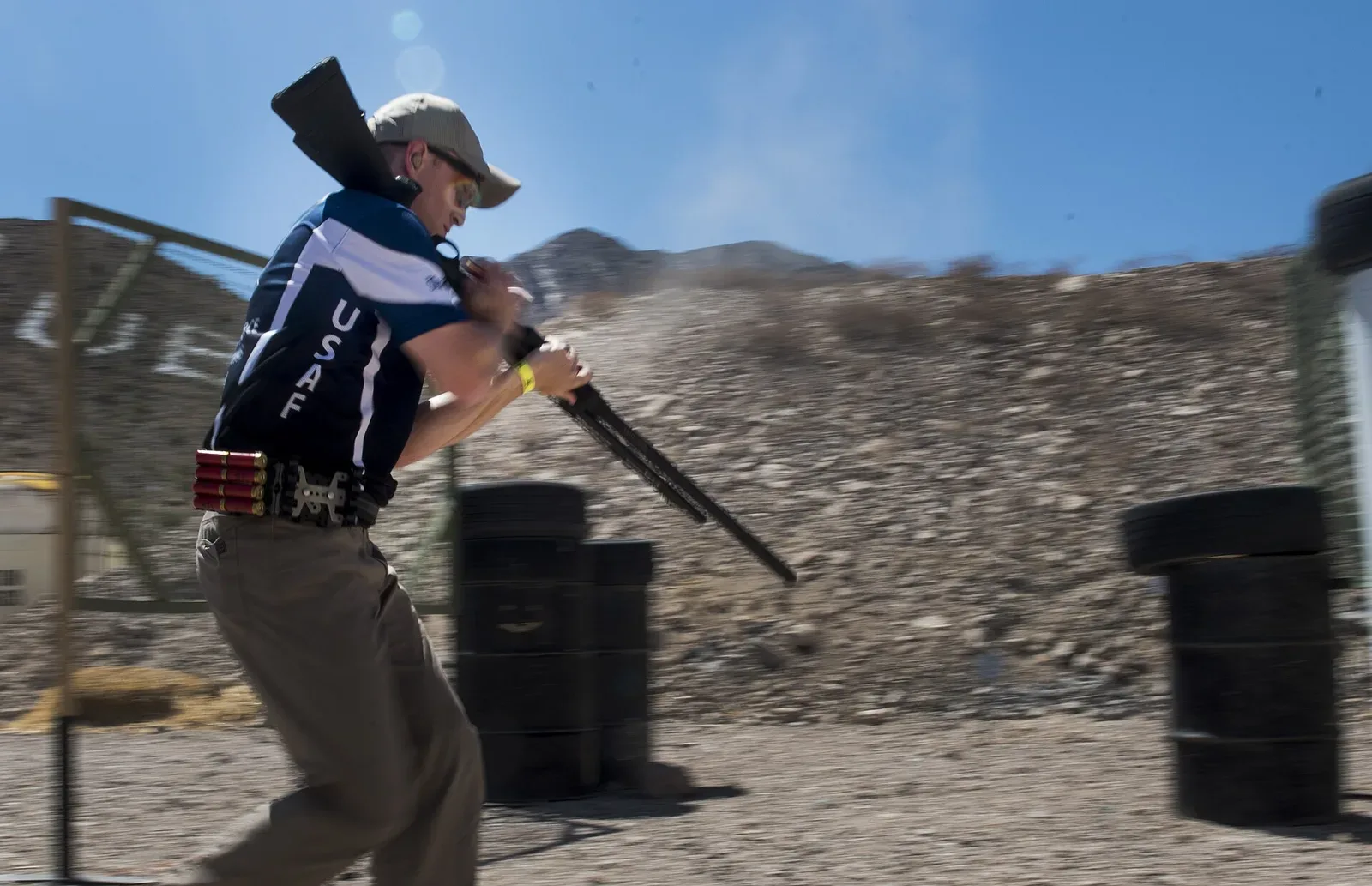 Competitor Casey Ryan in shooting stance during a shotgun stage at the 2018 USPSA Multigun Championship, demonstrating tactical shotgun handling in a competitive setting.