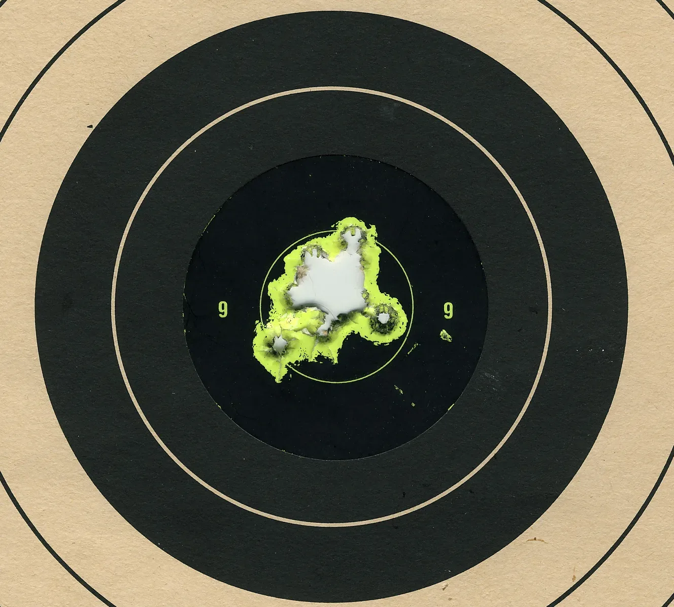A paper target with multiple bullet holes from a .223 Savage rifle, showing 25 shots clustered in the central scoring area