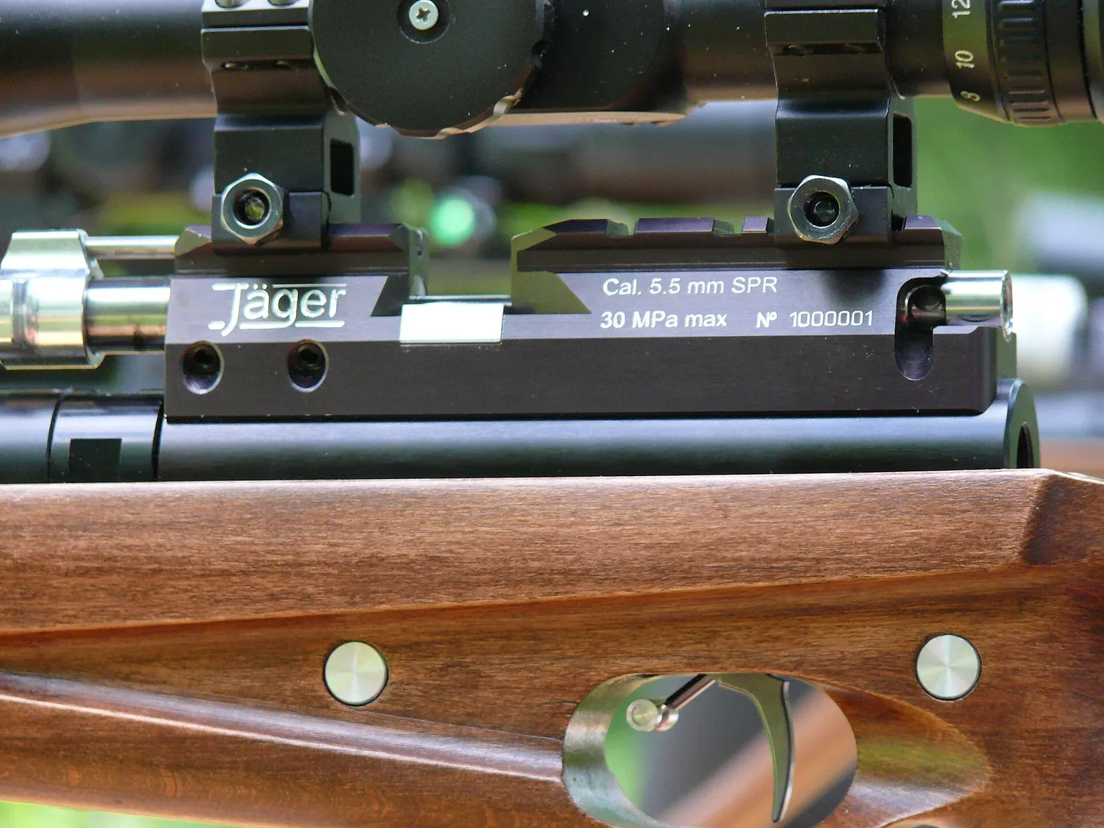Side profile view of a modern PCP air rifle showing the aluminum body, air reservoir, and mechanical components