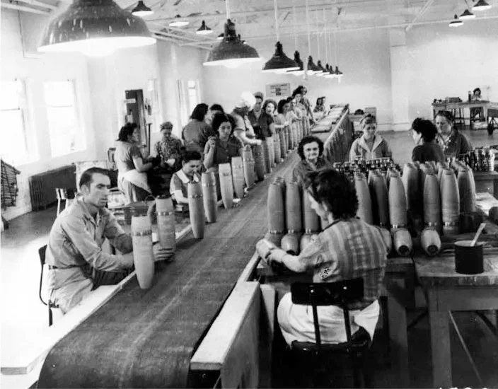 Interior view of munitions production facility at Redstone Arsenal during the 1940s, showing industrial manufacturing equipment and workers on the production floor