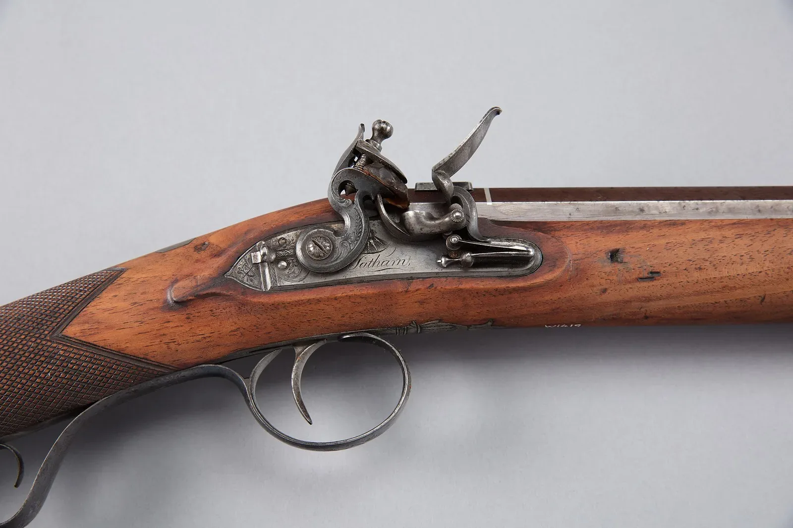 A side view of a muzzle-loading flintlock musket showing the full length of the barrel, stock, and flintlock mechanism with clear detail of the firing system.