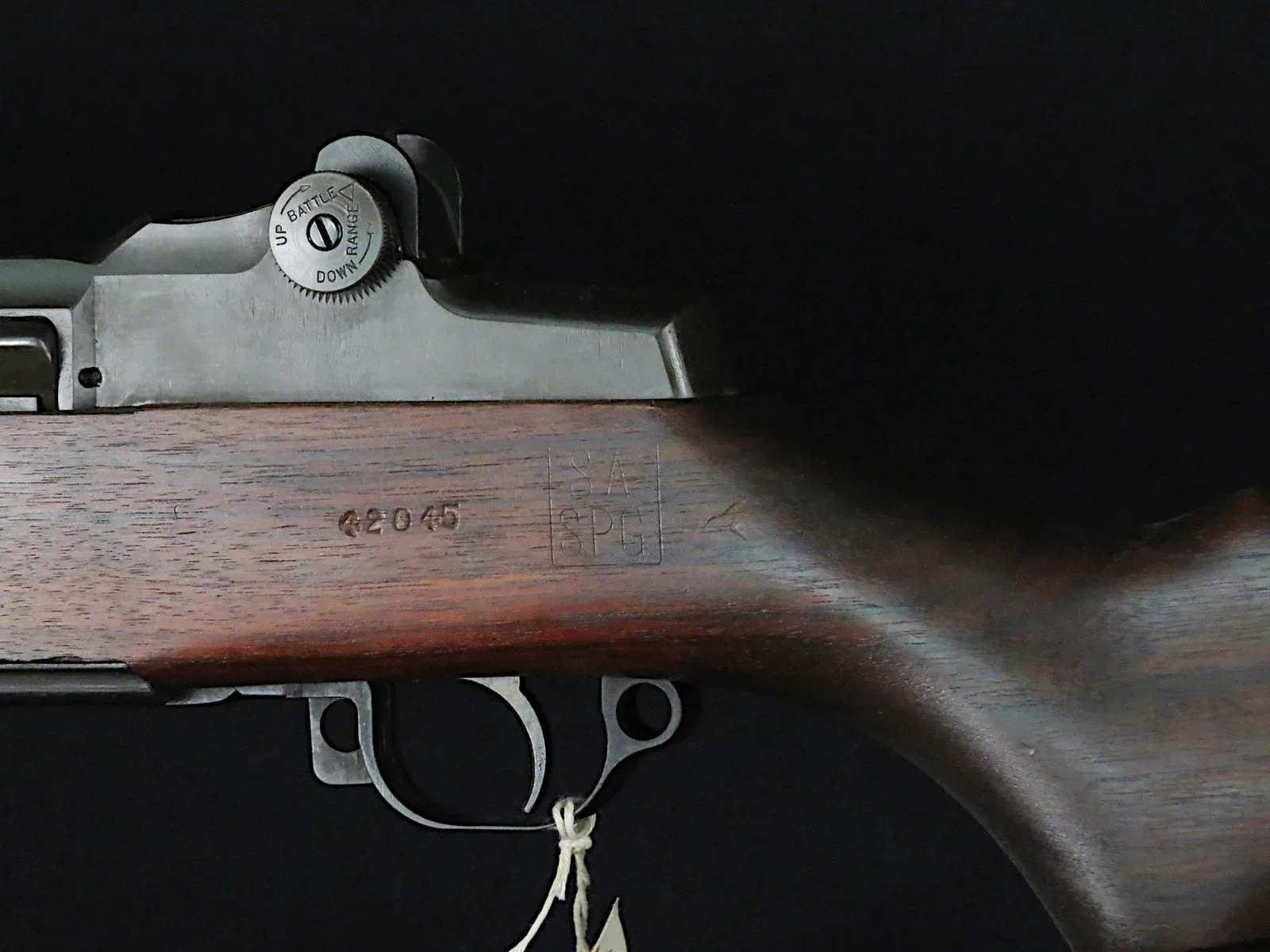 Springfield Armory M1 Garand rifle displayed against a neutral background, showing the full length of the rifle with its distinctive features clearly visible