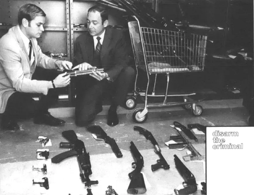ATF investigators displaying seized weapons on a table during an enforcement operation for violations of the Gun Control Act.