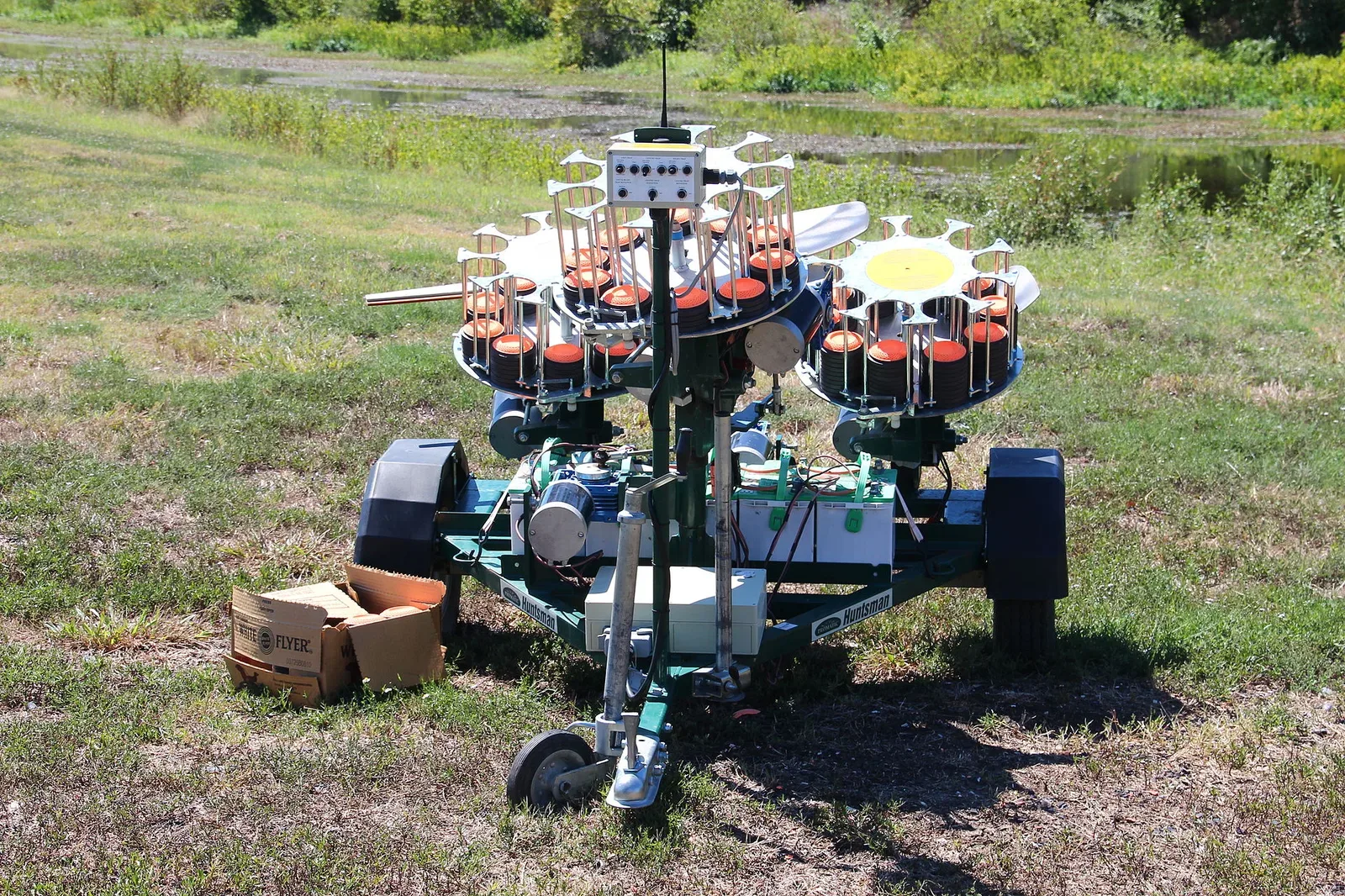 Portable automated mechanical clay pigeon thrower used in skeet shooting, showing the device that launches clay targets