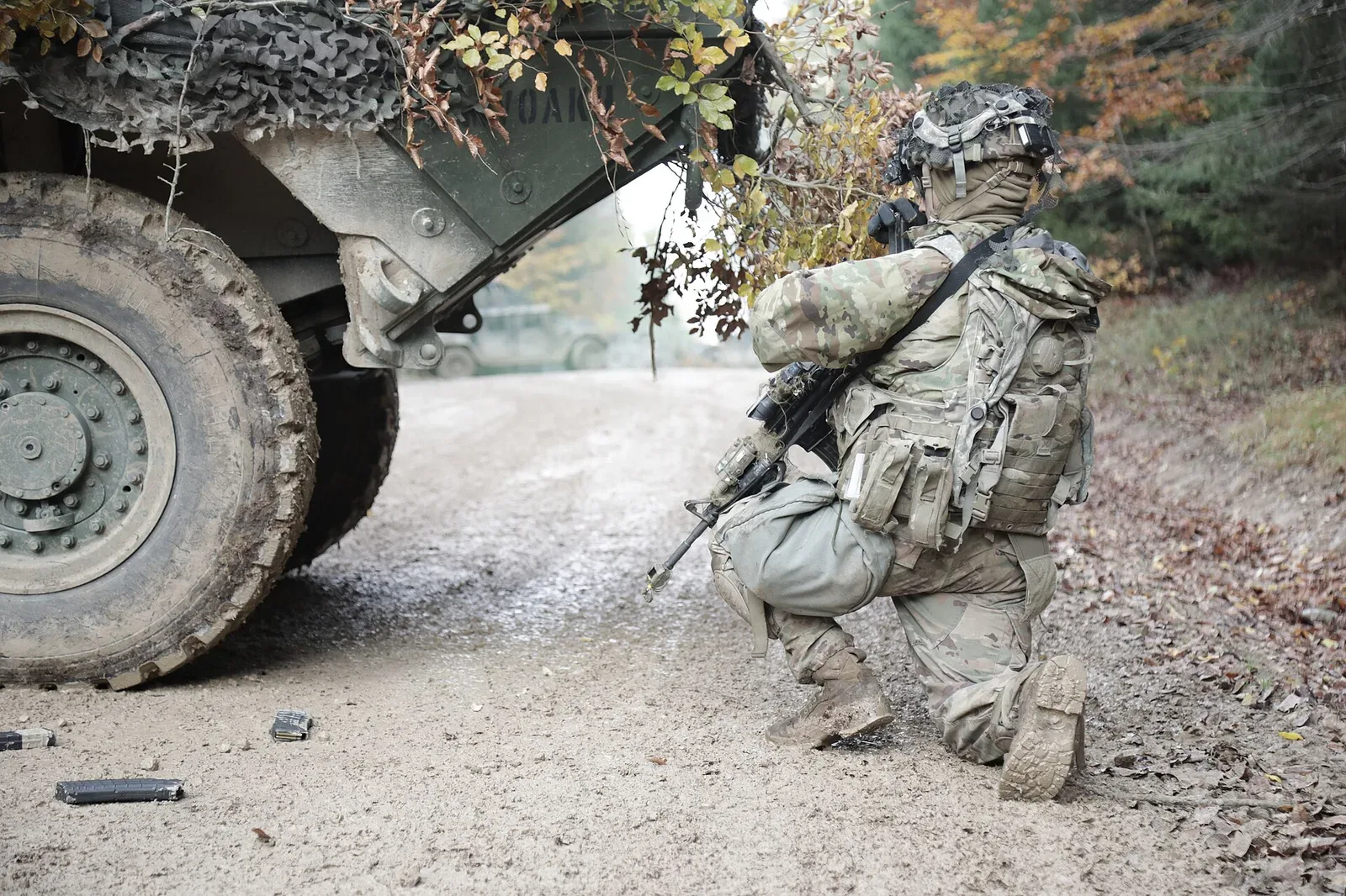 A workbench with various ammunition reloading components, tools, and finished rounds arranged for handloading ammunition