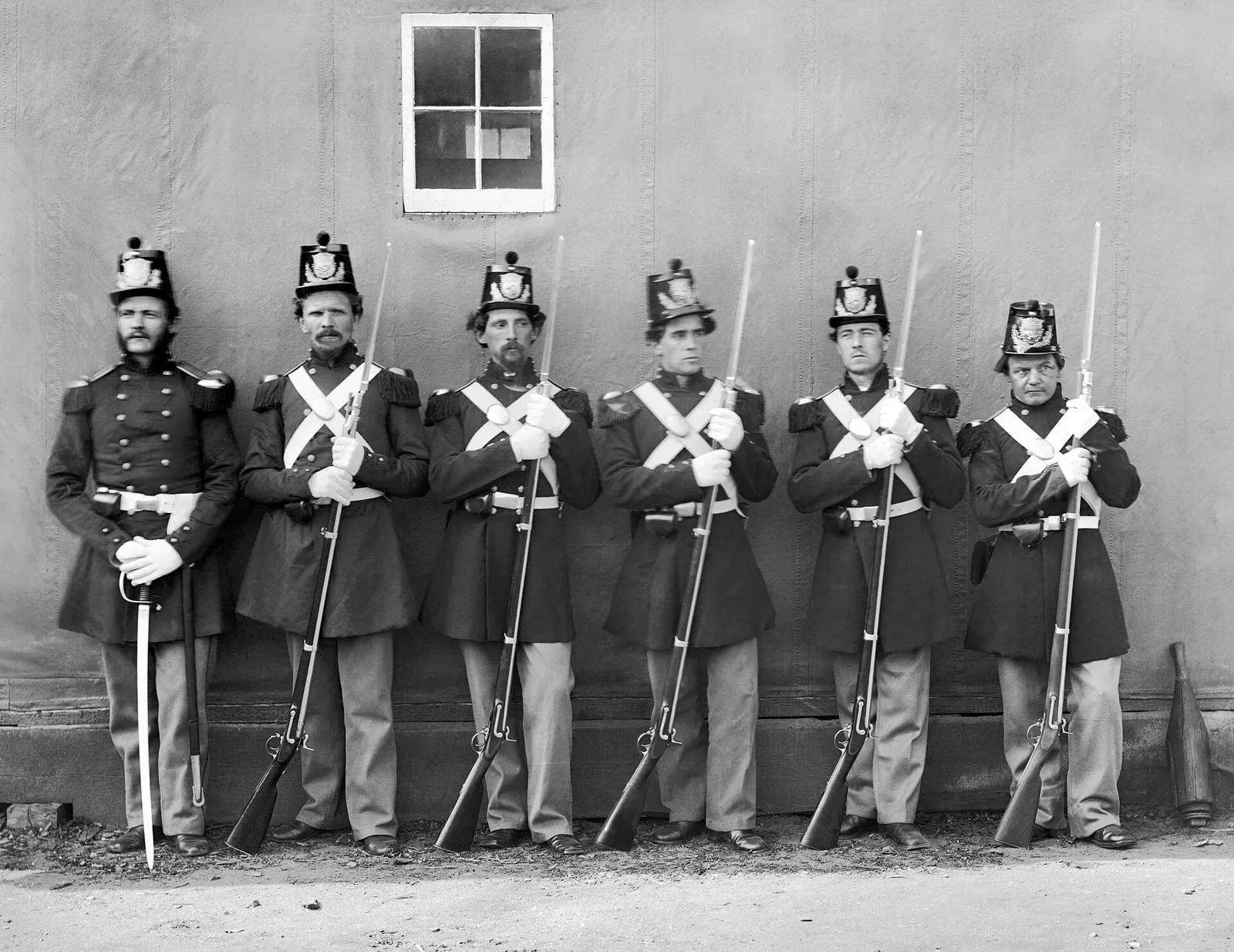 Five U.S. Marine Corps privates in military uniforms holding rifles with fixed bayonets, photographed in a military training or operational setting