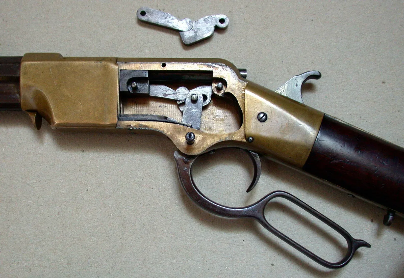 Internal mechanism of an 1860 Henry rifle receiver shown open, displaying the toggle-joint lever-action system