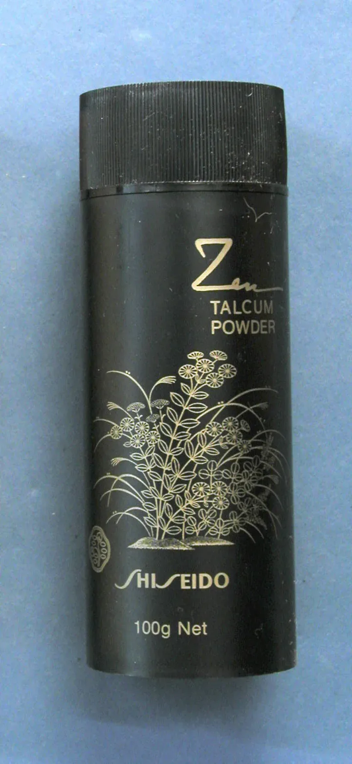 Historical black powder container with measurement markings and stopper, artifact in museum collection