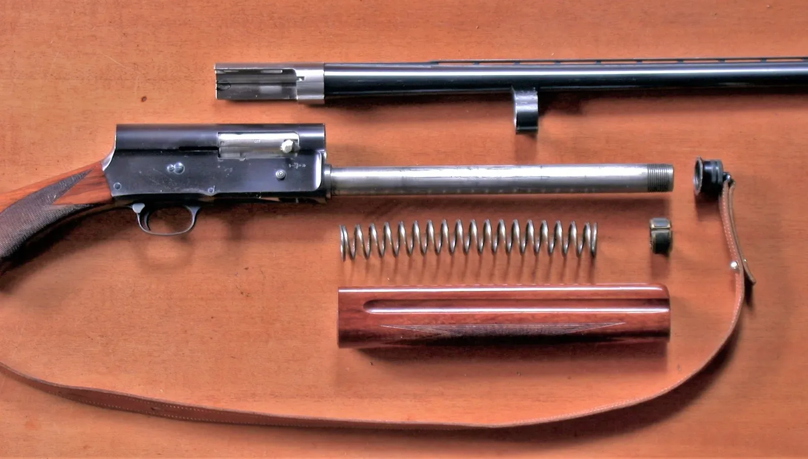 Browning Auto-5 shotgun with barrel removed, showing internal long-recoil operating system components and receiver assembly.