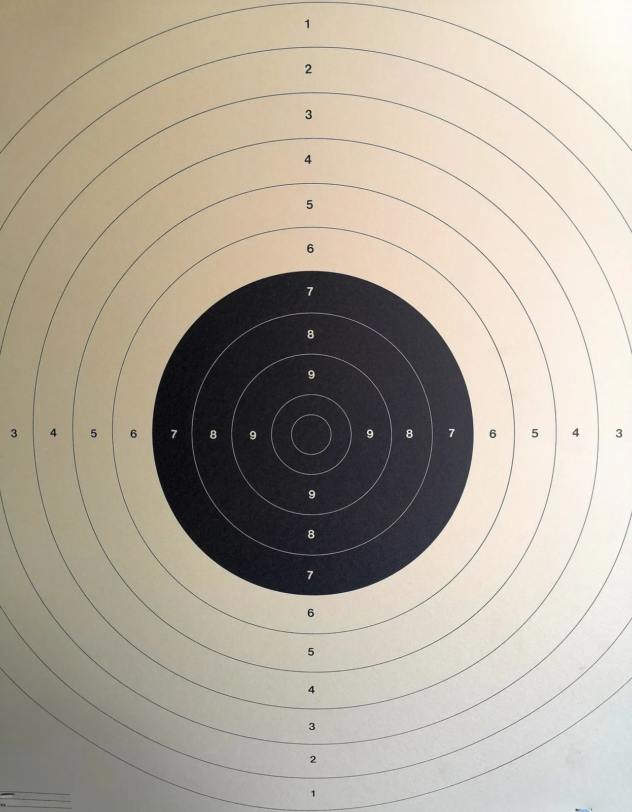 Standard ISSF bullseye target with concentric scoring rings in black and white, showing the 10-ring center and decreasing point values outward