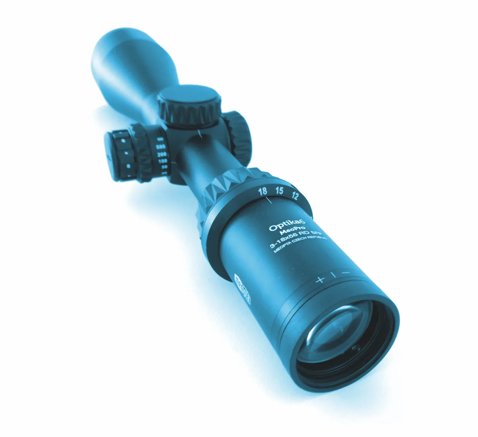 Close-up view of a rifle scope mounted on a firearm, showing the objective lens, turrets, and mounting rings in detail