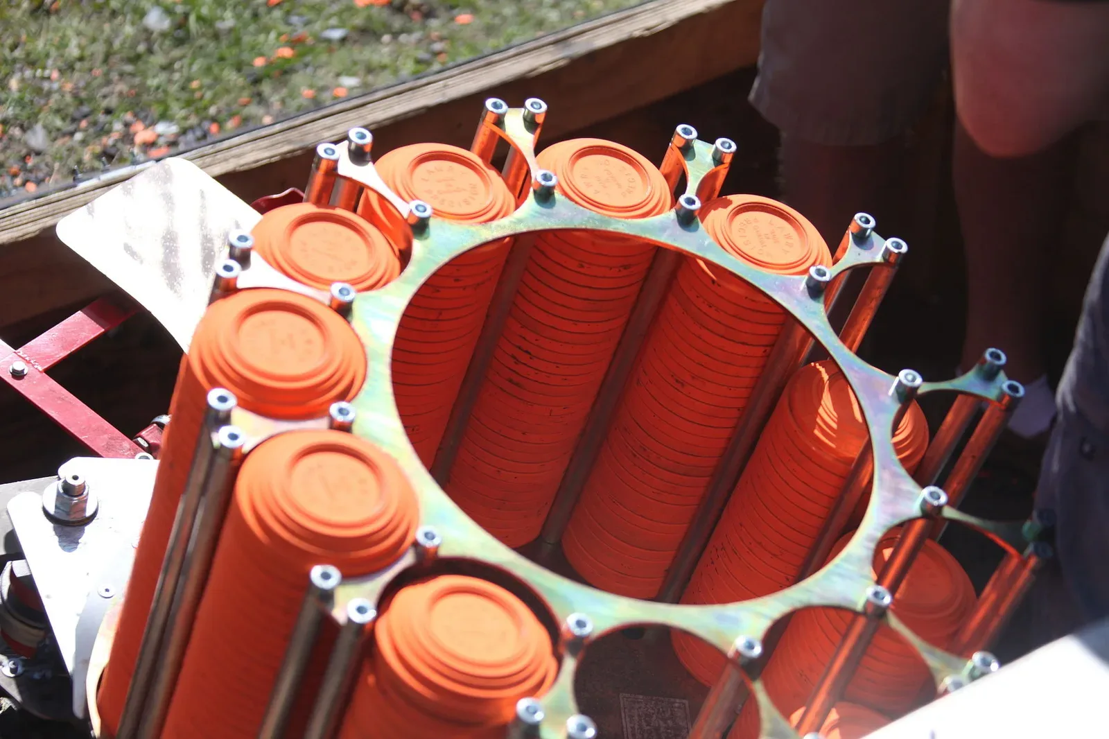 Shooters at a clay shooting competition station with trap machines visible in the background during a biannual skeet shoot event