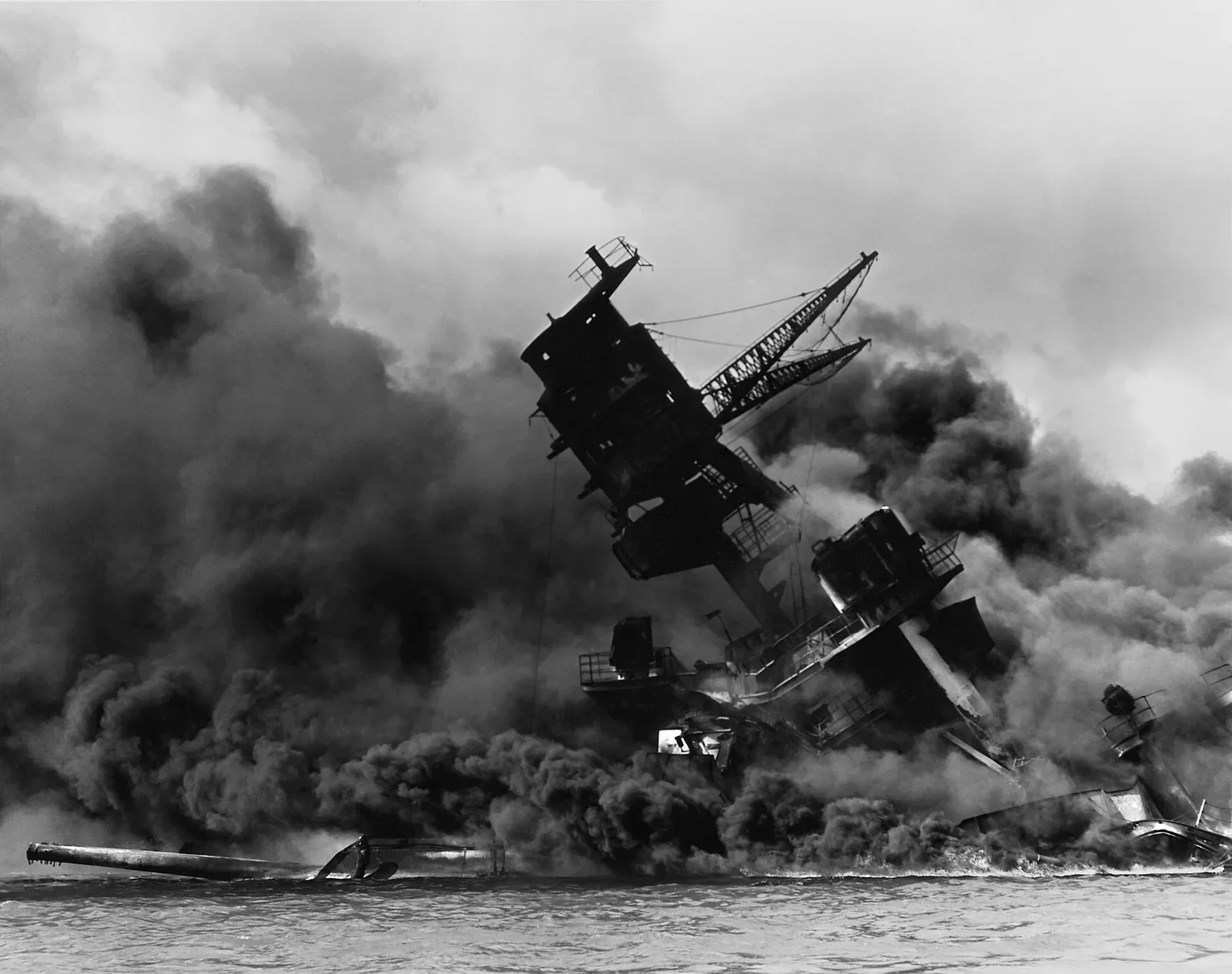The USS Arizona (BB-39) battleship burning and sinking in Pearl Harbor on December 7, 1941, following the Japanese attack.