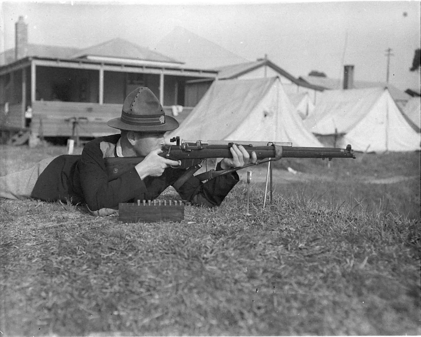 A group of men with rifles at an outdoor shooting range, circa 1930, identified as a National Rifle Association meeting at Anzac Rifle Range in Liverpool.