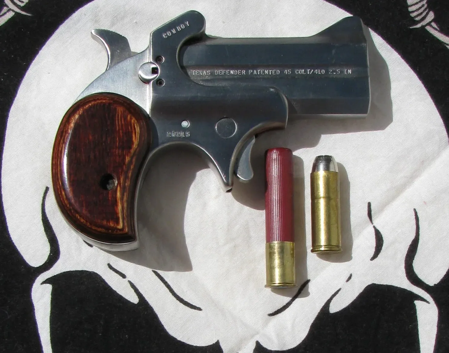 Bond Arms Cowboy Defender .45 .410 derringer with visible .410 gauge chamber, shown in side view against a neutral background