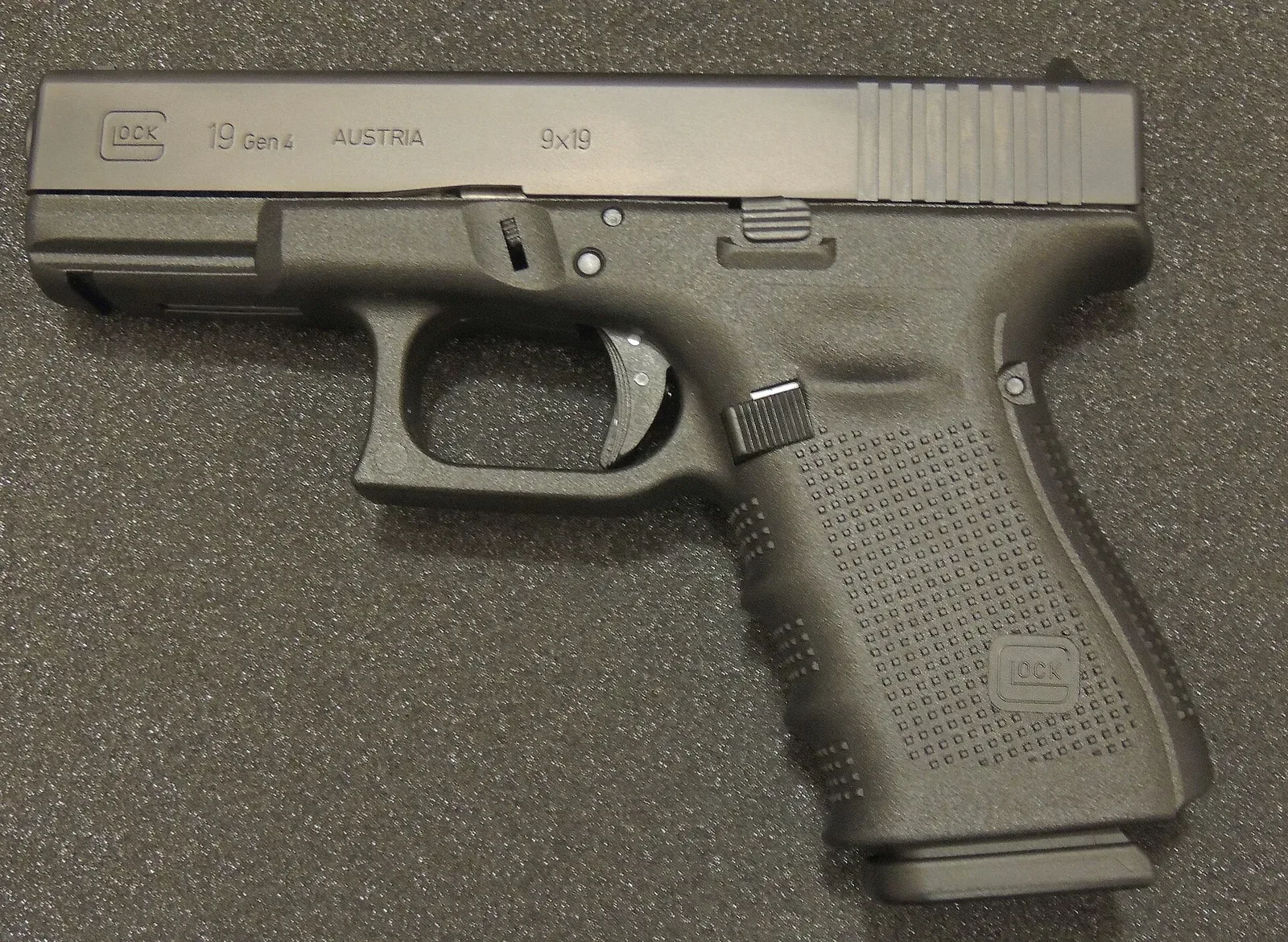 Glock 19 Gen 5 semi-automatic pistol, black polymer frame with metallic slide, shown in profile view