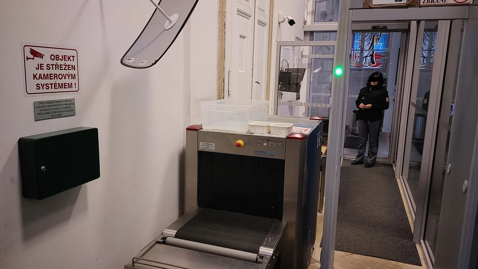 Security checkpoint with metal detection gateway at courthouse entrance