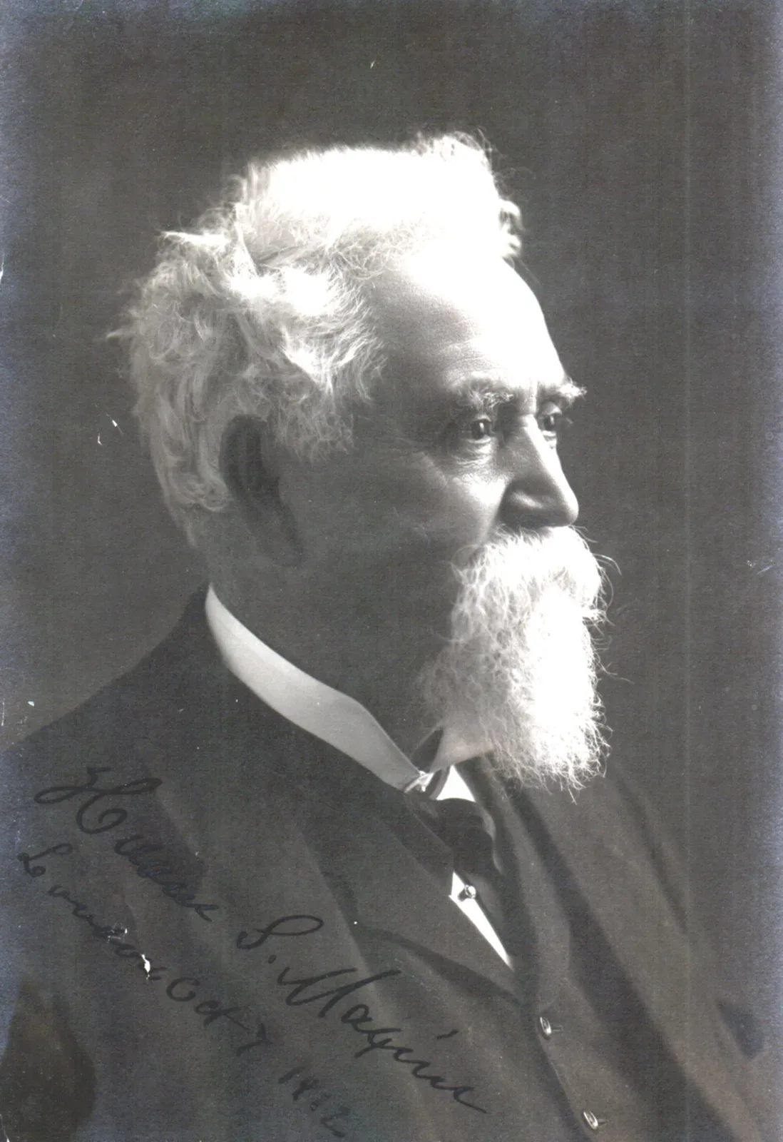 Portrait photograph of Hiram Stevens Maxim, a bearded man in formal Victorian-era dress, identified as the inventor of the machine gun