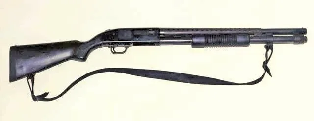 Mossberg 590 pump-action shotgun shown in side profile