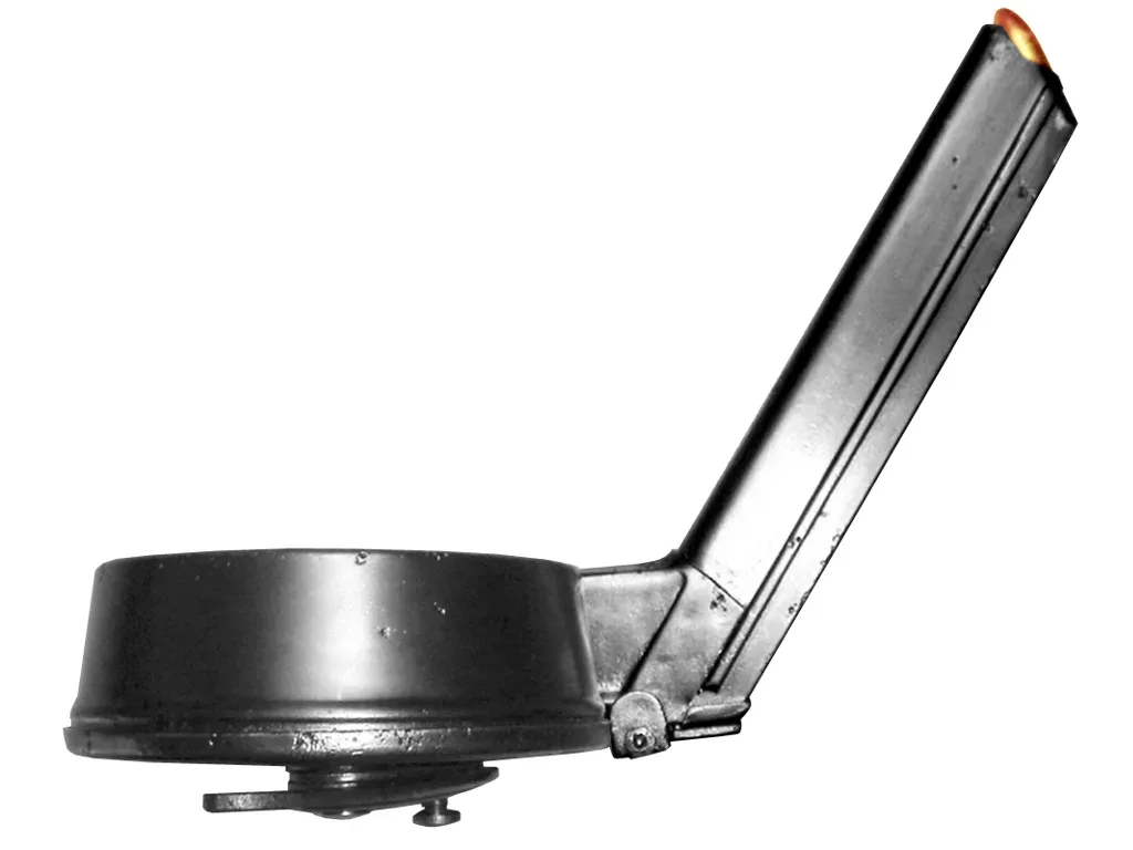 Close-up view of the TM 08 snail drum magazine mechanism showing the spiral spring-loaded ammunition feed system