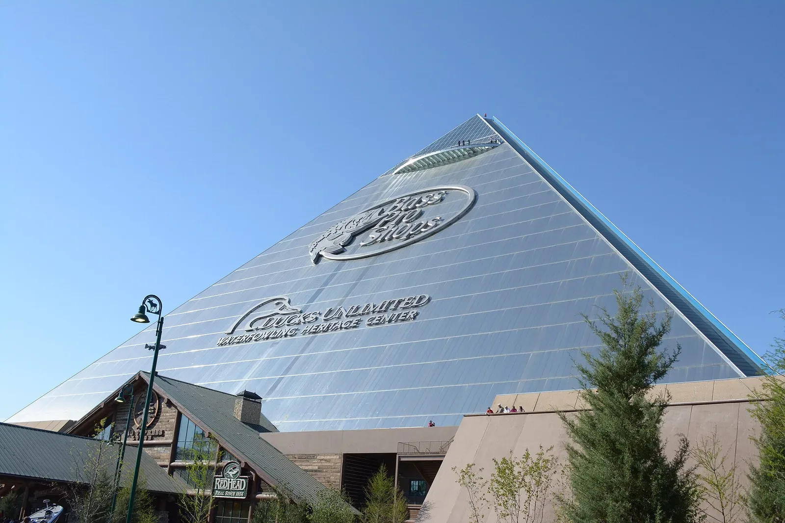 Exterior view of Bass Pro Shops flagship store located inside the Memphis Pyramid, a distinctive blue-grey pyramidal structure in Memphis, Tennessee.