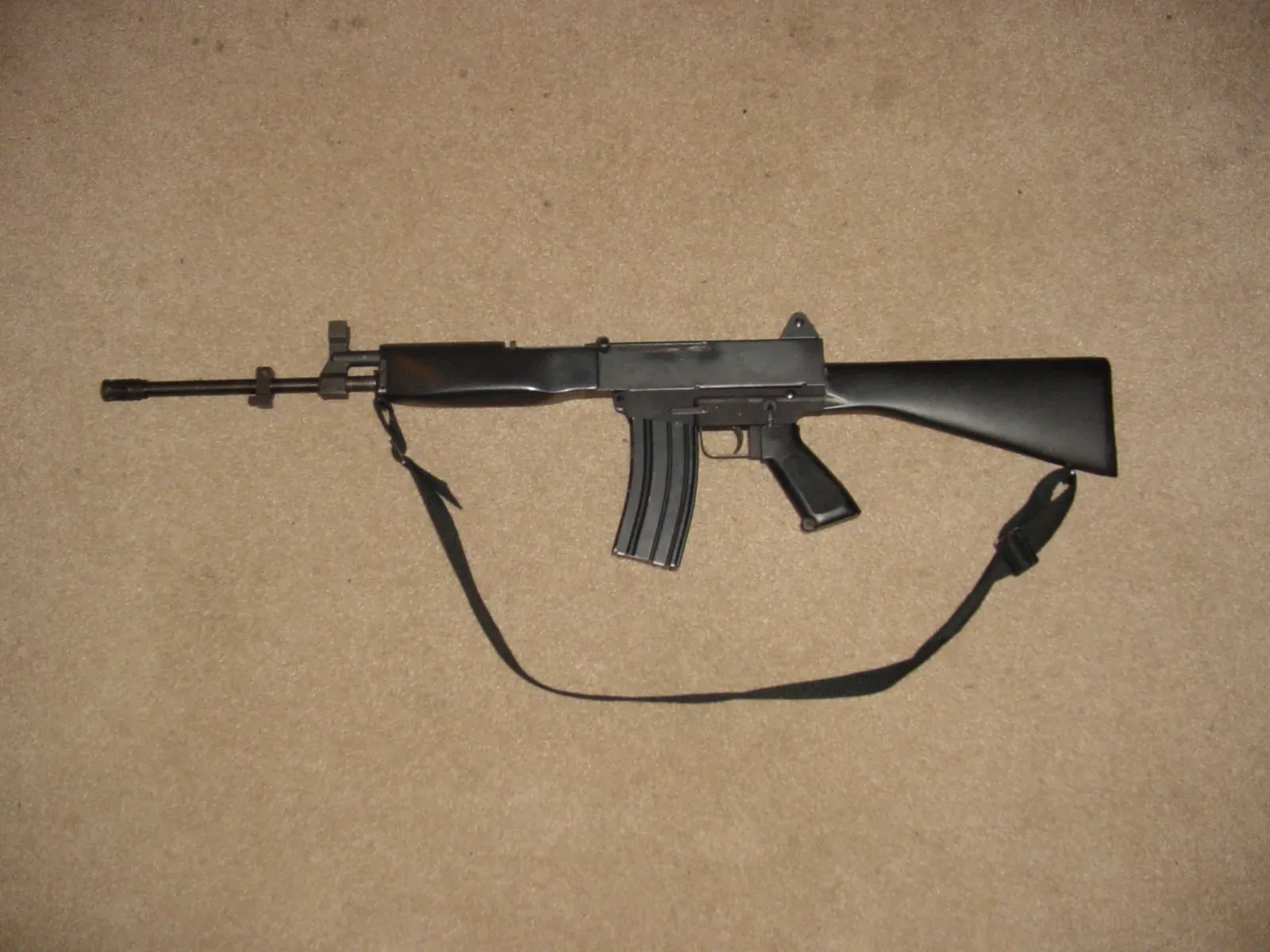 First Generation Bushmaster Assault Rifle with wooden furniture and fixed stock, early production model marketed by Gwinn Firearms