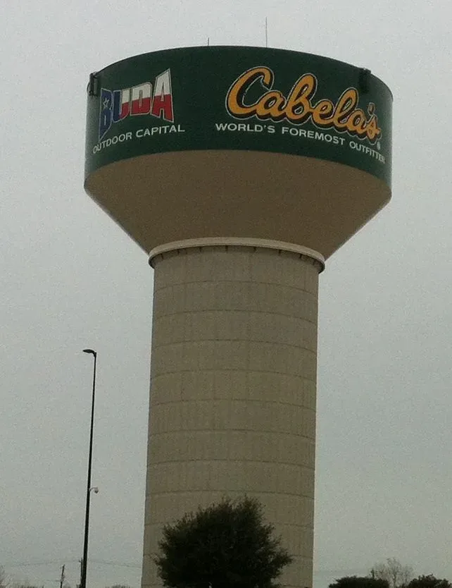 Water tower at Cabela's retail location in Buda, Texas, displaying the company name and stylized city branding