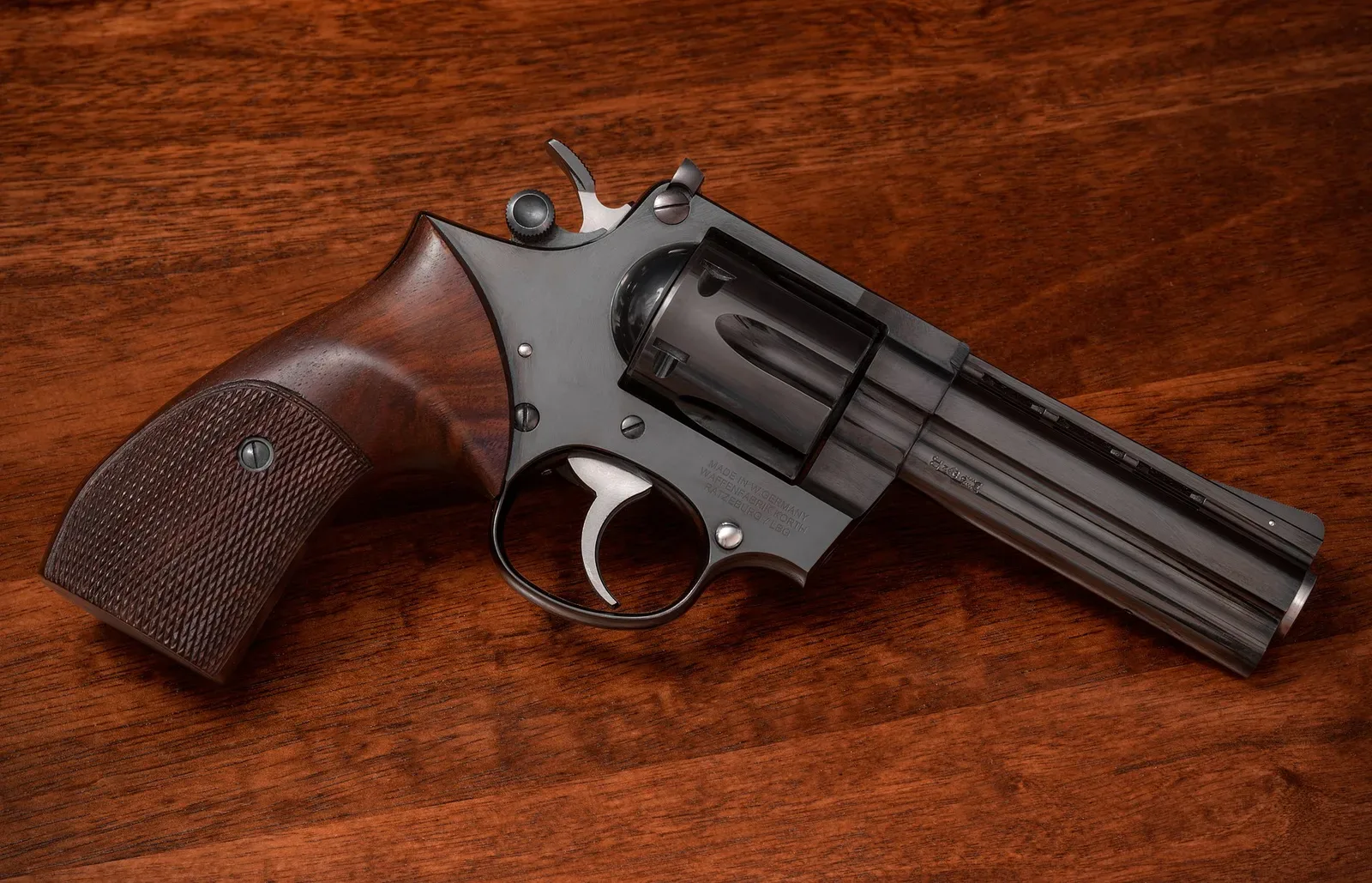 A precision German-made Korth Combat revolver photographed from above, showing detailed craftsmanship of the barrel, cylinder, and grip