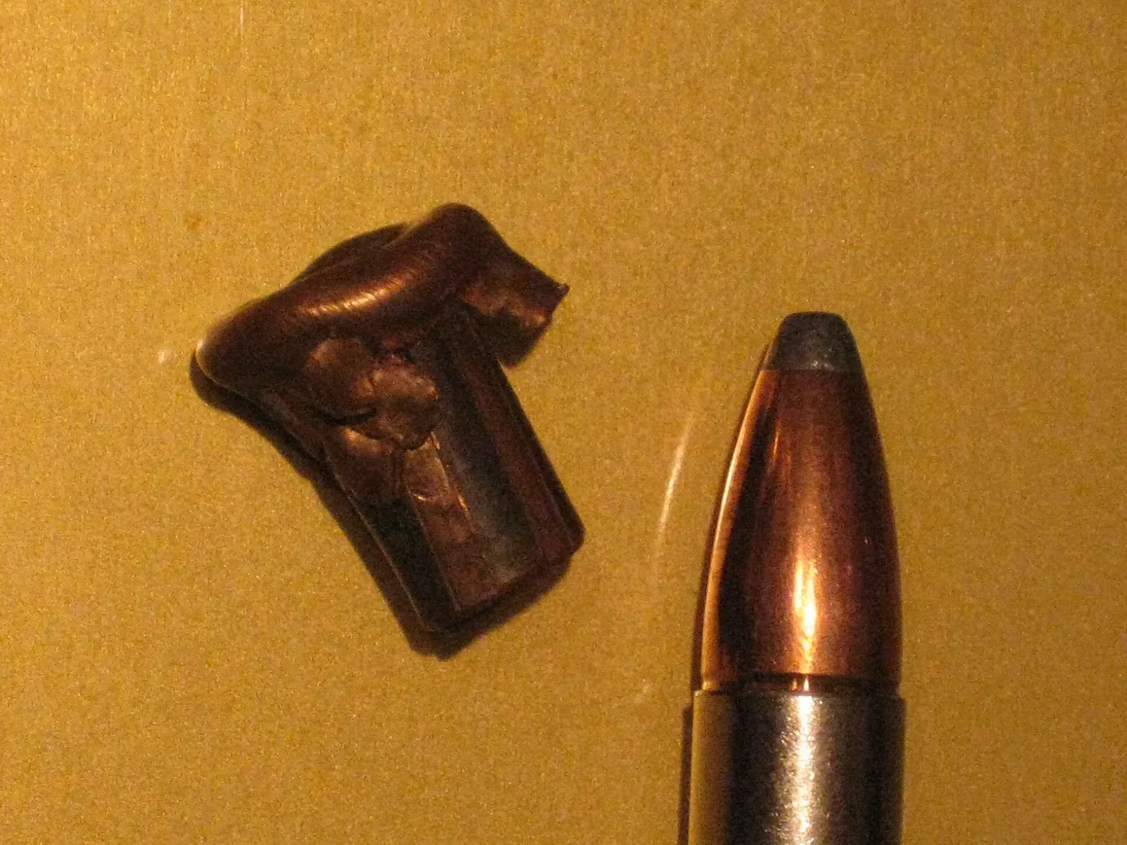 Cross-section view of a .375 H&H Nosler Partition bullet showing the dual-core construction with lead front and rear sections separated by a copper partition