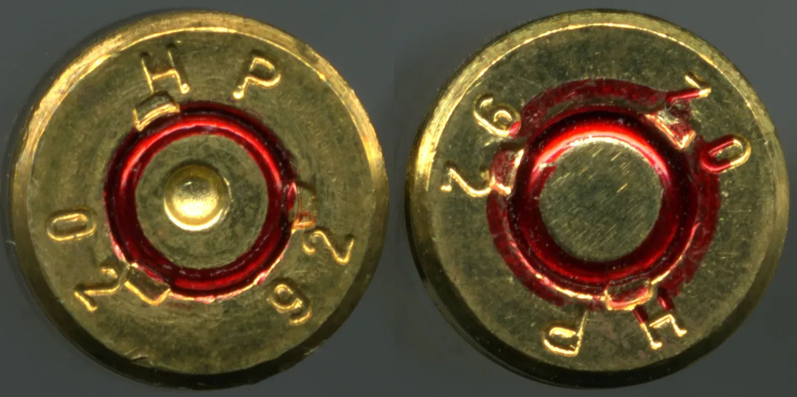 Side-by-side comparison of a fired 5.56×45 NATO cartridge on the left and an unfired cartridge on the right, showing the visual difference in their casings.