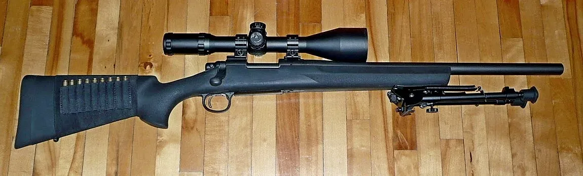 Remington 700 SPS Tactical rifle with synthetic furniture and heavy barrel, shown in profile against neutral background.