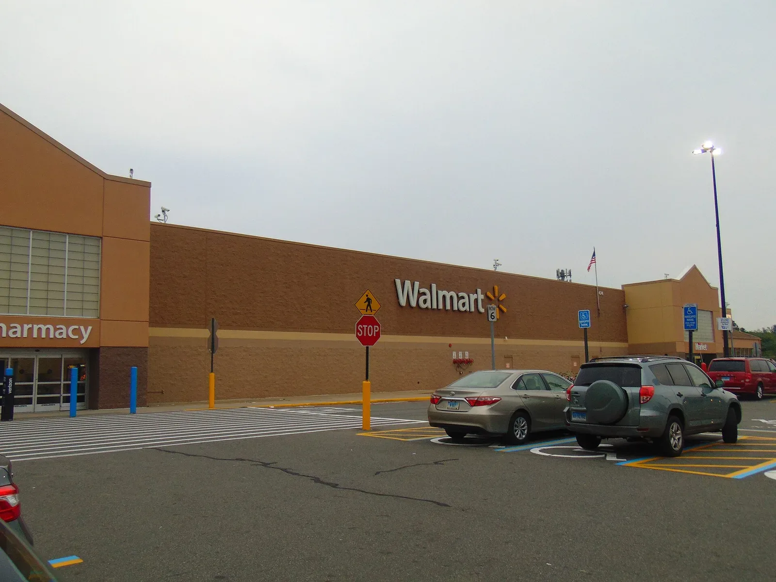 Exterior of a Walmart Supercenter in North Windham, Connecticut, showing the large rectangular building structure characteristic of 1990s Supercenter design with prominent signage.