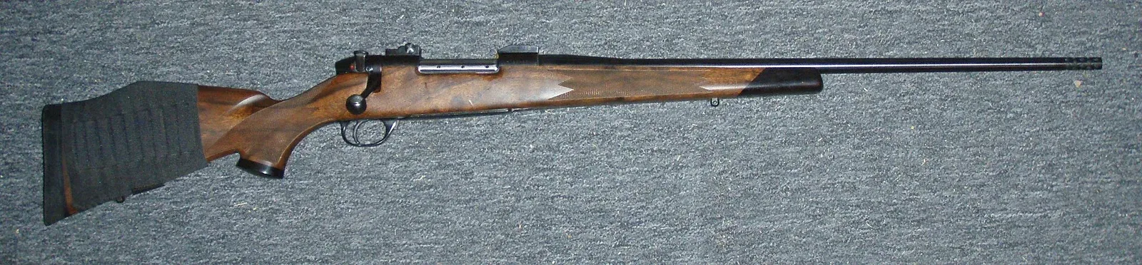 Weatherby Mark V Ultramark bolt action rifle shown in profile view, displaying the complete rifle configuration and nine-lug bolt design