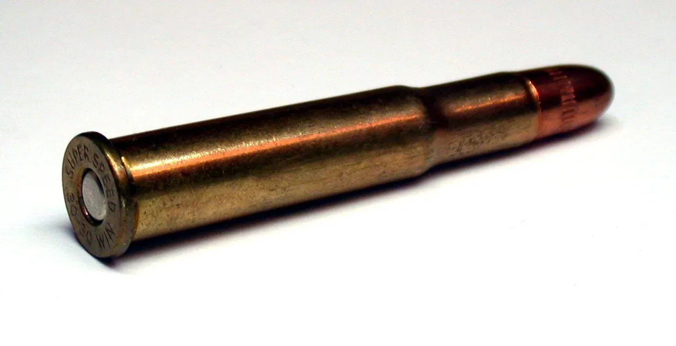 A .30-30 Winchester cartridge displayed against a neutral background, showing the distinctive bottleneck brass case and lead bullet.