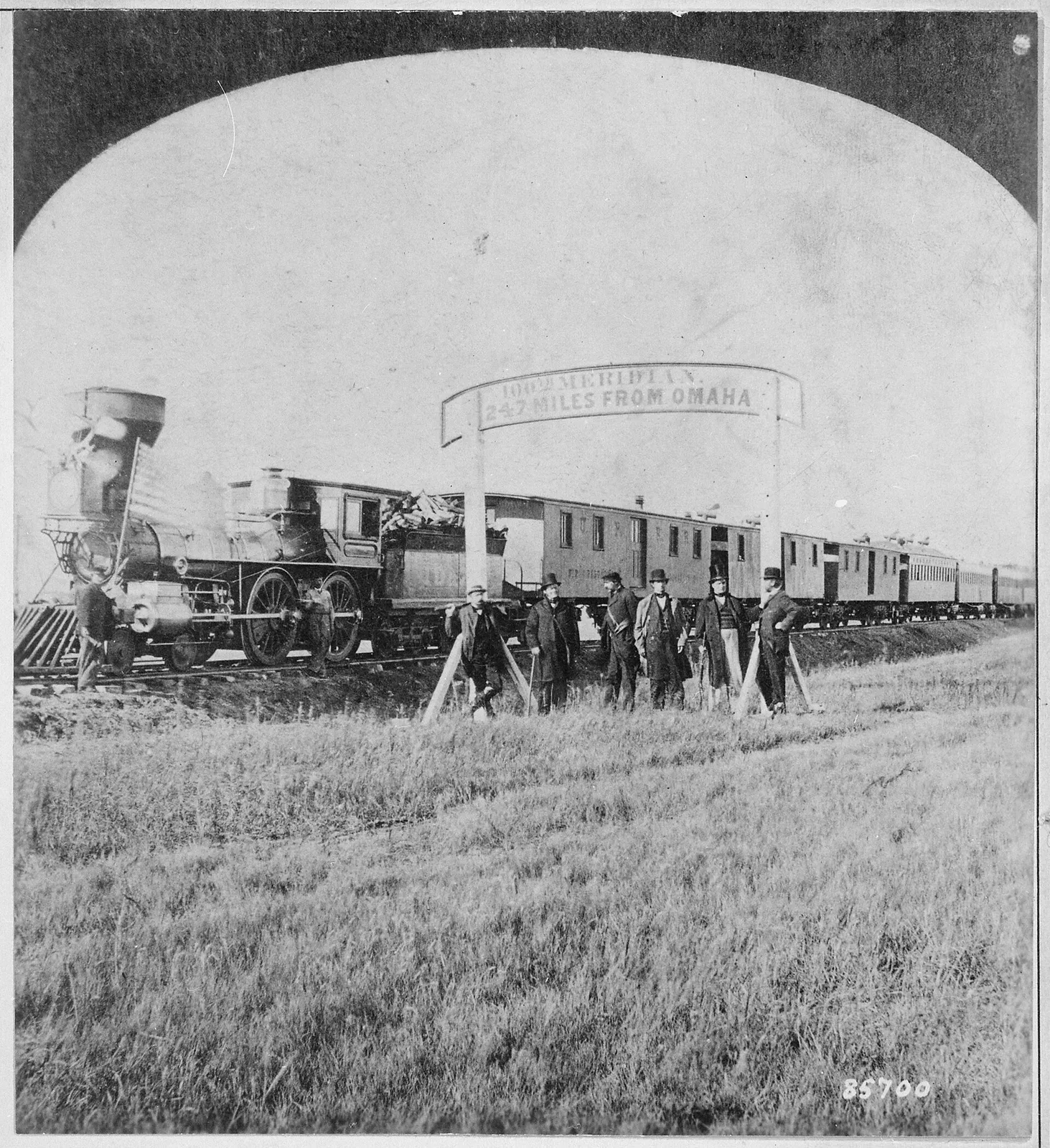 Photograph of Union Pacific Railroad directors and officials standing on the railroad tracks at the 100th meridian, approximately 250 miles west of Omaha, Nebraska Territory, circa 19th century.