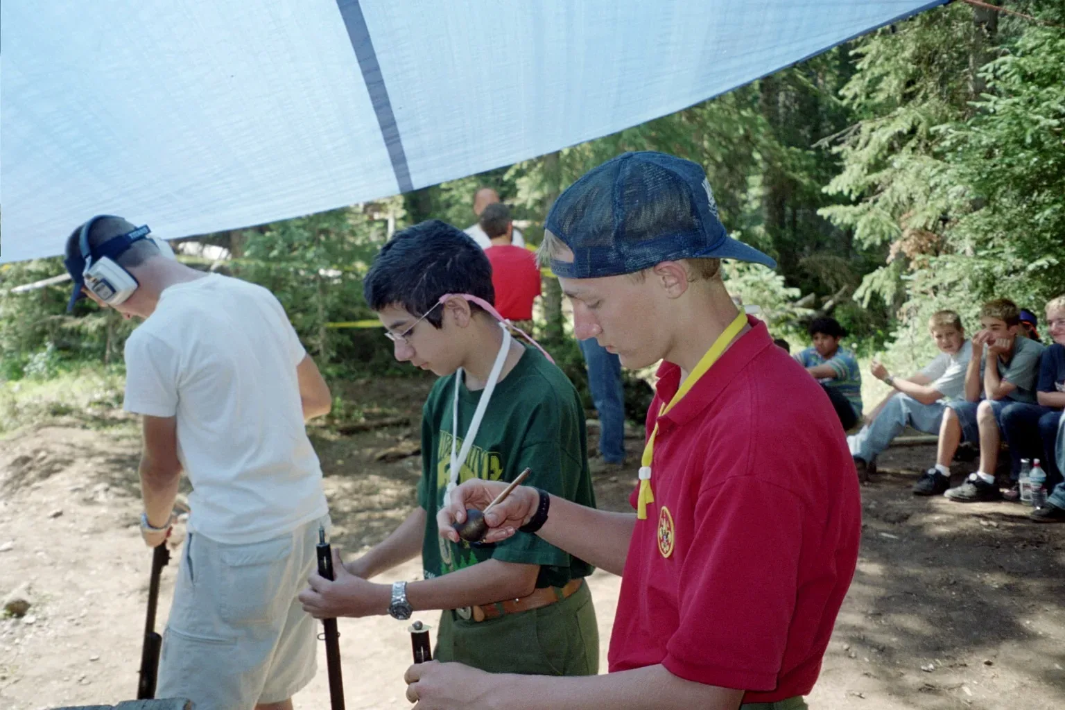 Varsity Scouts handling and preparing black powder rifles during a Frontiersman shooting activity in 2004.