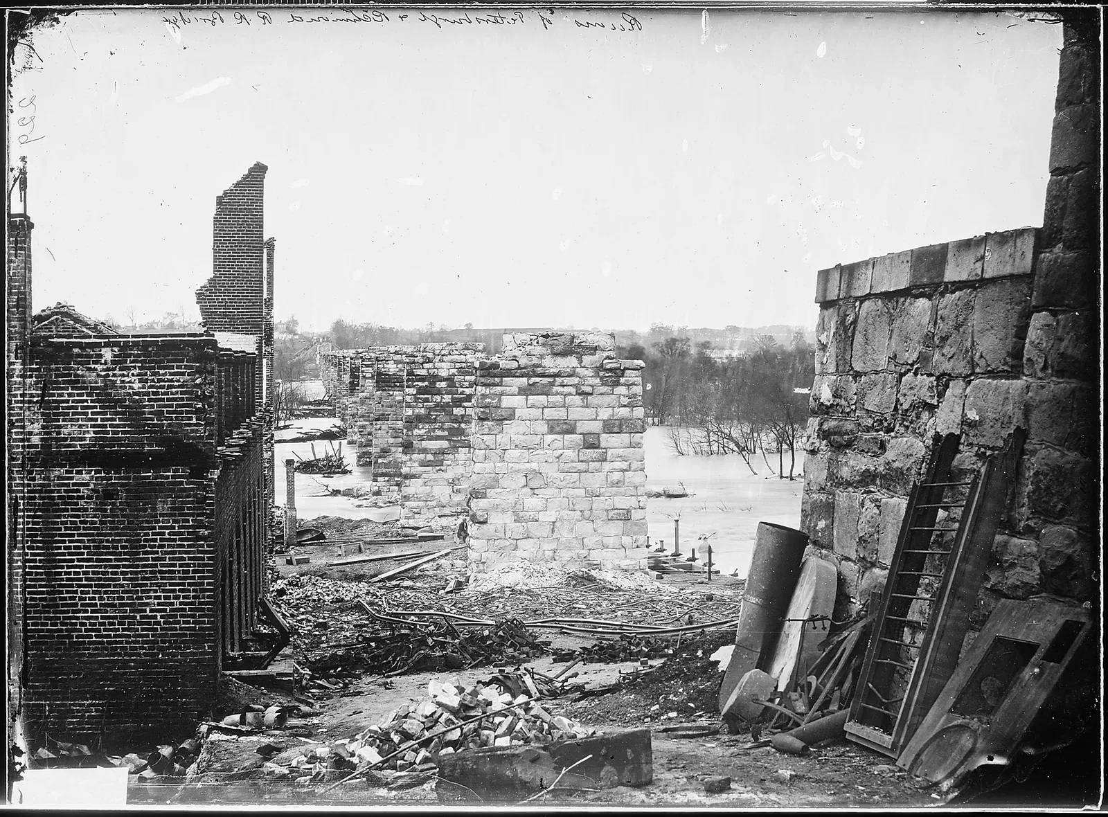 Ruins of Petersburg Railroad Bridge in Richmond, Virginia, photographed in April 1865, showing destroyed infrastructure and industrial damage from the American Civil War