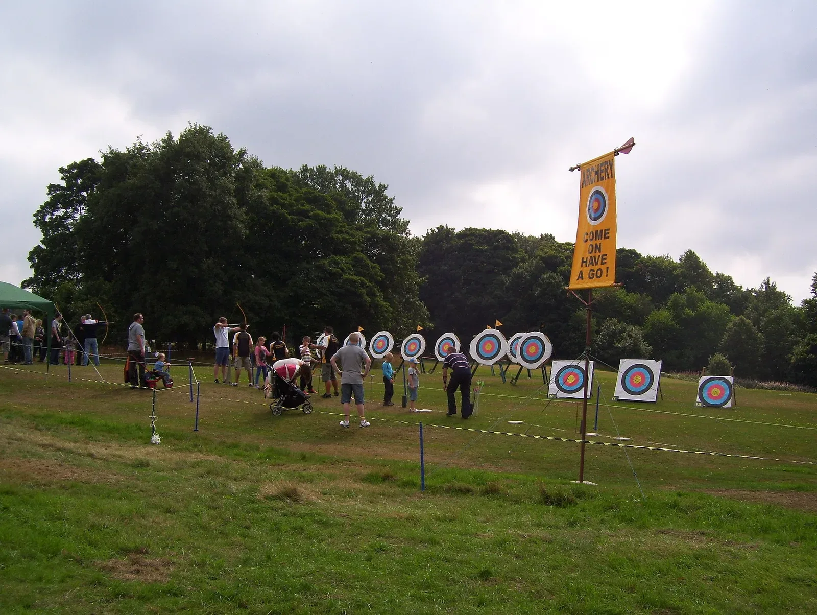Outdoor archery range with multiple shooting stations and targets set up on grass, demonstrating organized competitive archery facility