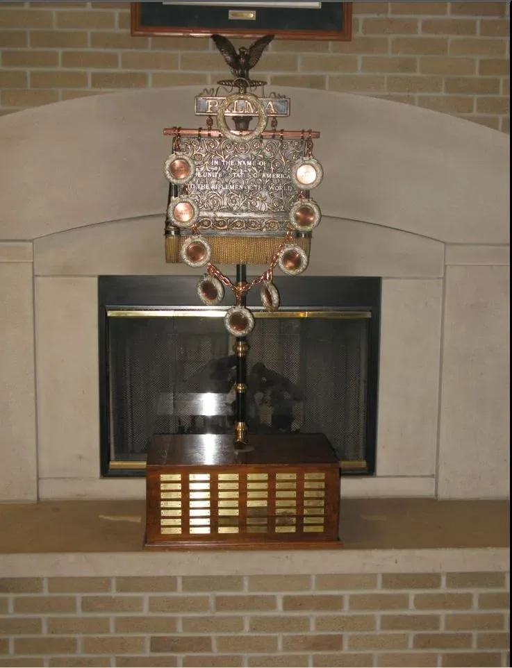 The Palma Trophy, a ornate silver and gold cup with handles and decorative base, used for the world team championship in fullbore rifle shooting.