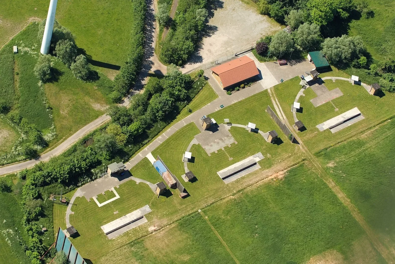 Aerial photograph of a skeet and trap shooting range in Cuxhaven, Germany, showing the field layout with shooting stations and target throw positions.