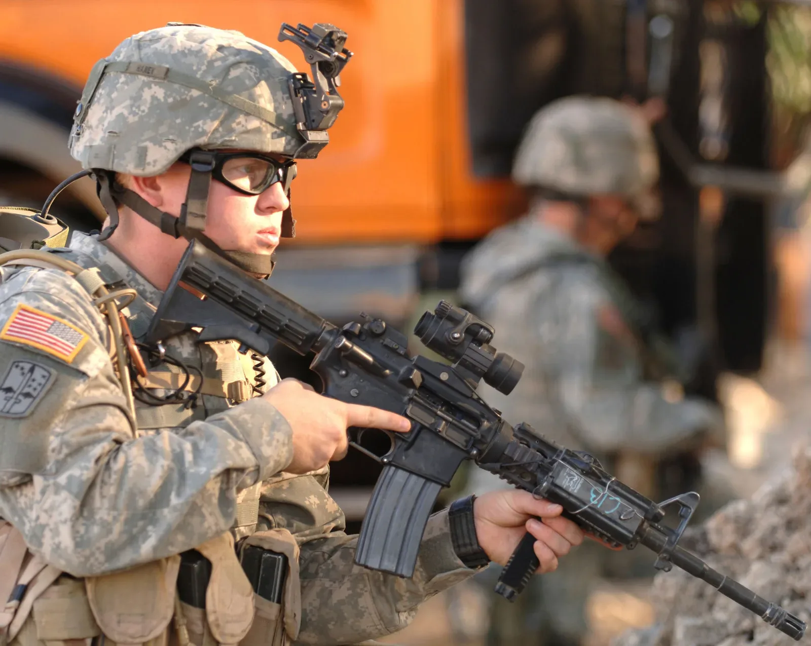 M4 carbine equipped with Picatinny rails and mounted tactical accessories, held by Spc. Nicholas Haney from the 23rd Infantry Regiment during operations in Iraq