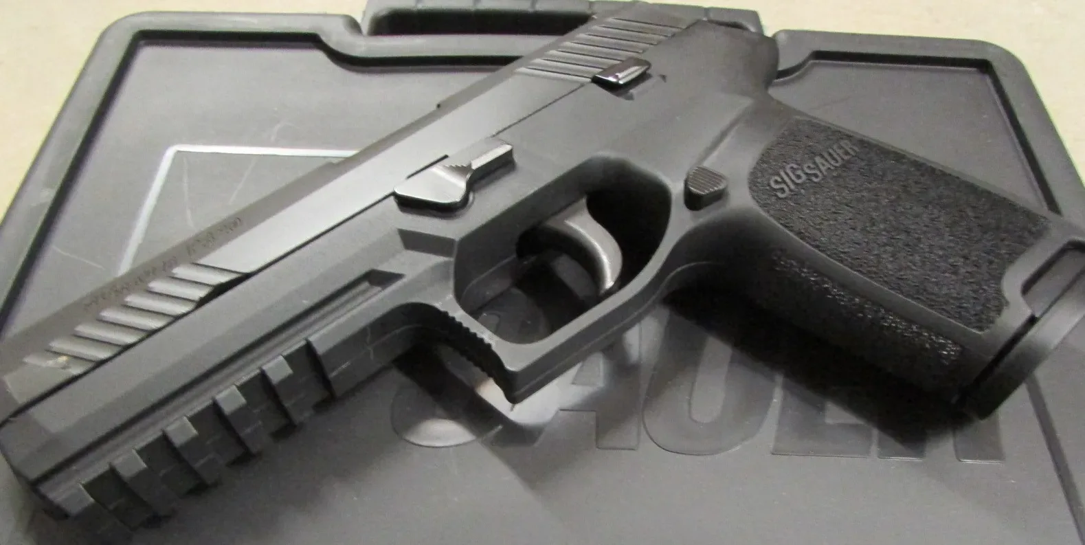 SIG Sauer P320 semi-automatic pistol in 9mm caliber, shown in profile against a neutral background.