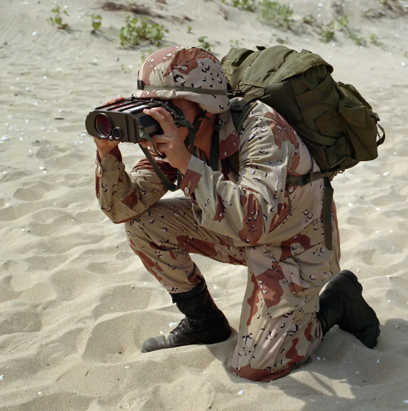 Captain Milton Eng field testing a GVS-5 laser rangefinder during military operations