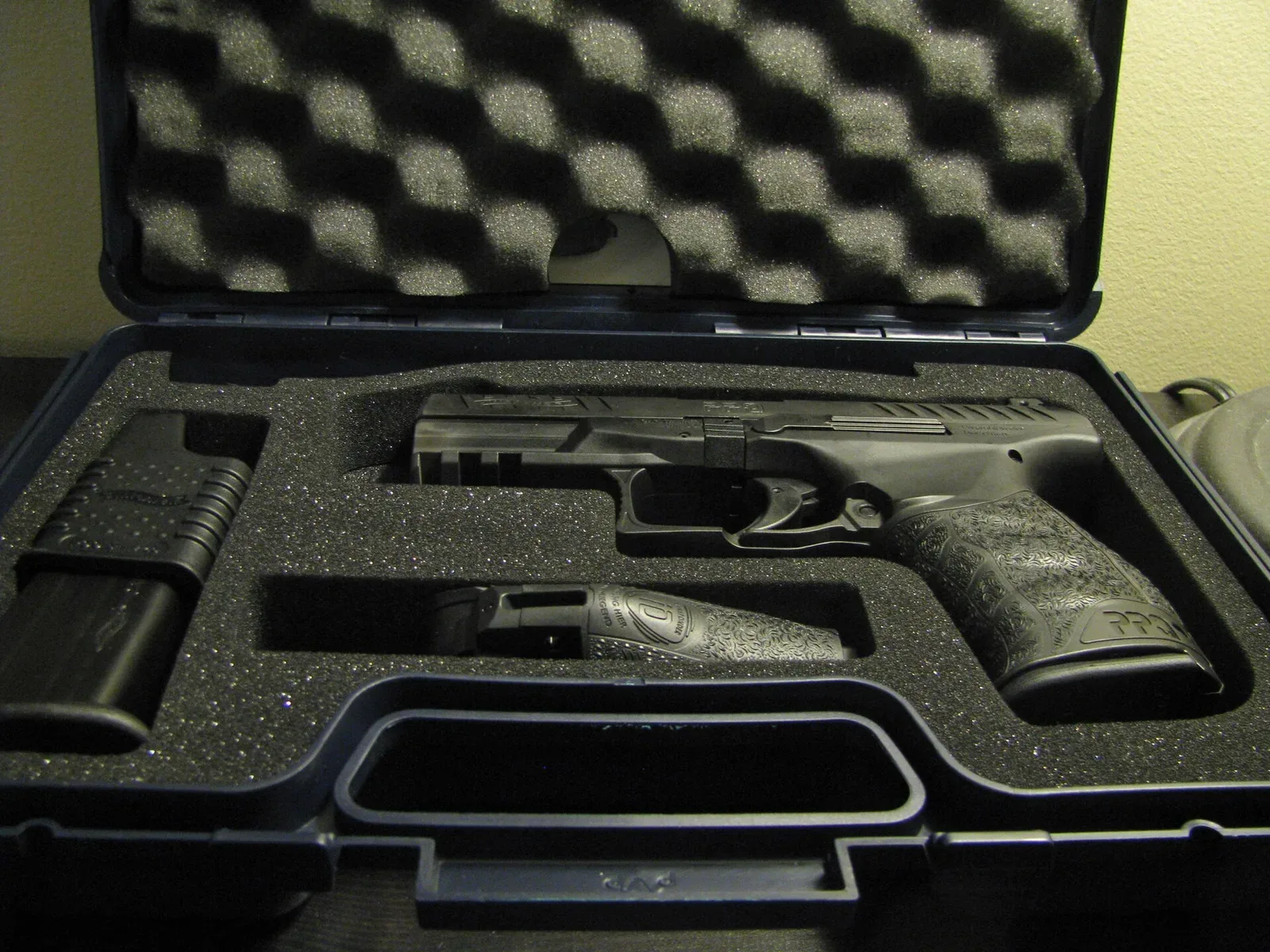 Walther PPQ pistol displayed in its factory hardcase with foam cutout, showing the complete retail presentation package